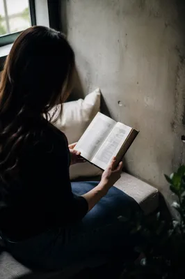 Peaceful Woman Reading Bible by Window