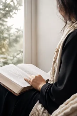 Woman Reading Bible by Bright Window