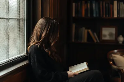 Woman Reading Bible by Frosted Window