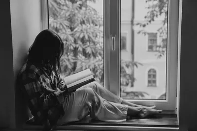 Woman Reading Bible by Quiet Window