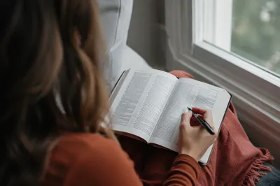Woman Reading Bible by Sunlit Window
