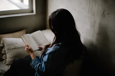 Woman Reading Bible by Quiet Window
