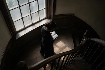 Woman Reading Bible by Window Light