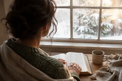 Woman Reading Bible by Frosted Window