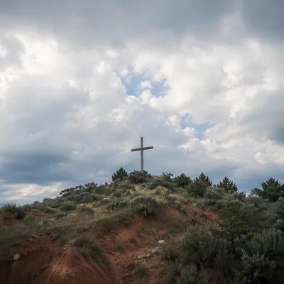 Weathered Wooden Cross on Dramatic Hilltop