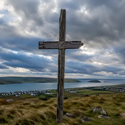 Weathered Cross on Hilltop Beneath Dramatic Sky