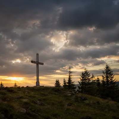 Wooden Cross on Hilltop Under Dramatic Sky