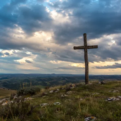 Weathered Wooden Cross Beneath Dramatic Evening Sky