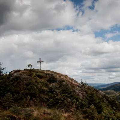 Wooden Cross on Hilltop Under Dramatic Sky