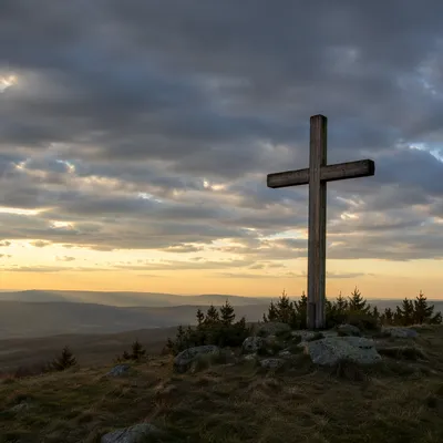 Wooden Cross on Hilltop Under Dramatic Sky