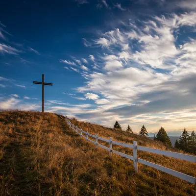 Wooden Cross on Hilltop Under Dramatic Sky