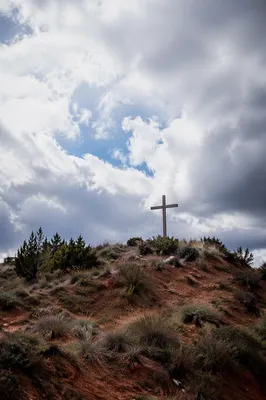 Weathered Wooden Cross on Dramatic Hilltop