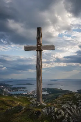Weathered Wooden Cross on Dramatic Hilltop