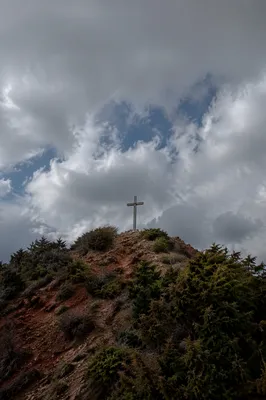 Wooden Cross on Rugged Hilltop Sky