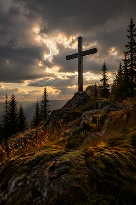Weathered Wooden Cross Beneath Stormy Golden Sky
