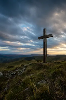 Weathered Wooden Cross Beneath Dramatic Evening Sky
