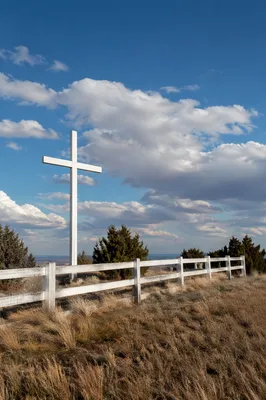 White Wooden Cross on Hilltop Sky