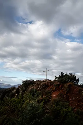 Weathered Wooden Cross Beneath Dramatic Sky