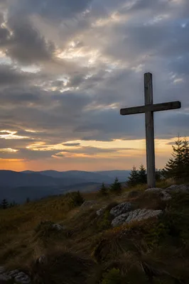 Weathered Wooden Cross on Dramatic Hilltop