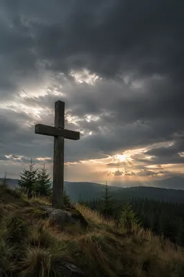Weathered Cross Above Evergreen Storm Clouds