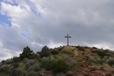 Weathered Wooden Cross on Dramatic Hilltop