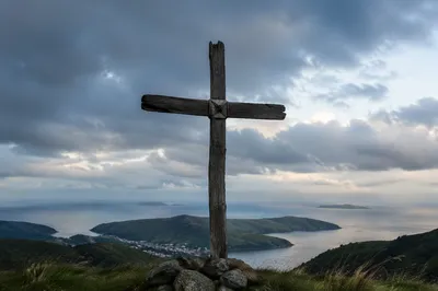 Weathered Wooden Cross Above Dramatic Coastal Sky