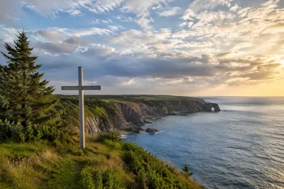 Weathered Cross Above Evergreen Coastal Cliffs