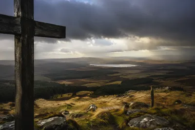 Wooden Cross on Windswept Hilltop