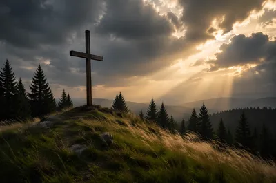 Wooden Cross on Evergreen Hill at Sunset