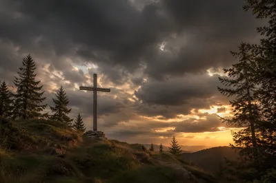 Wooden Cross on Hilltop Under Dramatic Sky