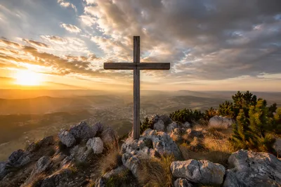 Wooden Cross on Hilltop at Sunset