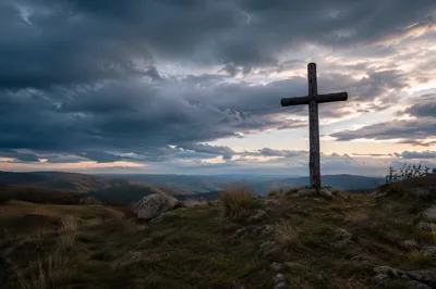 Weathered Wooden Cross Beneath Dramatic Evening Sky