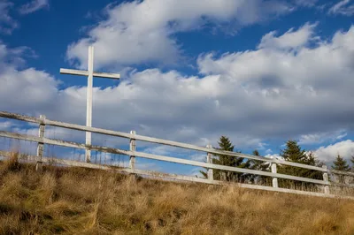 White Wooden Cross on Hilltop Sky