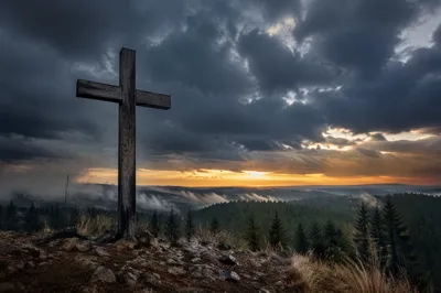 Wooden Cross on Evergreen Hill at Sunset