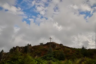 Wooden Cross on Hilltop Under Dramatic Sky