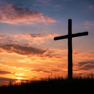 Wooden Cross Silhouette at Peaceful Sunrise