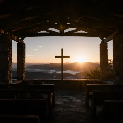 Wooden Cross Silhouette at Mountain Sunrise