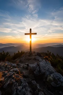 Wooden Cross Silhouette at Mountain Sunrise