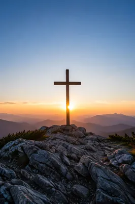 Wooden Cross Silhouette at Mountain Sunrise
