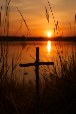 Rustic Wooden Cross at Lakeside Sunrise