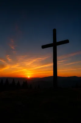 Wooden Cross Silhouette at Evergreen Sunrise