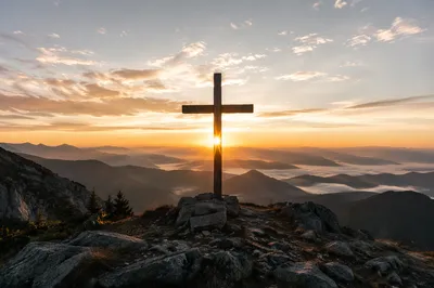 Wooden Cross Silhouette at Mountain Sunrise