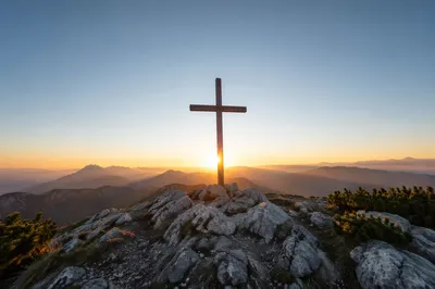 Wooden Cross Silhouette at Mountain Sunrise