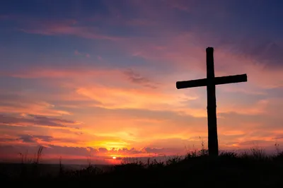 Wooden Cross Silhouette at Peaceful Sunrise