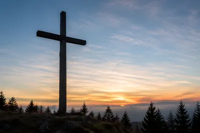 Wooden Cross Silhouette at Evergreen Sunrise
