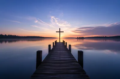 Wooden Cross Silhouette at Sunrise Lake
