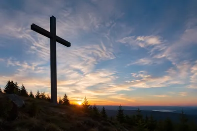 Wooden Cross Silhouette at Evergreen Sunrise