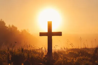 Wooden Cross Silhouette at Sunrise Meadow