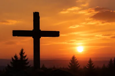 Wooden Cross Silhouette at Golden Sunrise