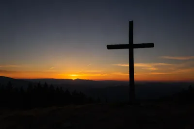 Wooden Cross Silhouette at Evergreen Sunrise